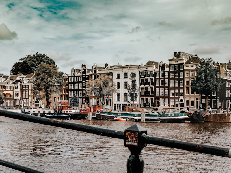 a view of a river with buildings and a parking meter in the foreground