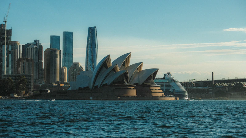 Sydney opera house stands tall over the harbor.